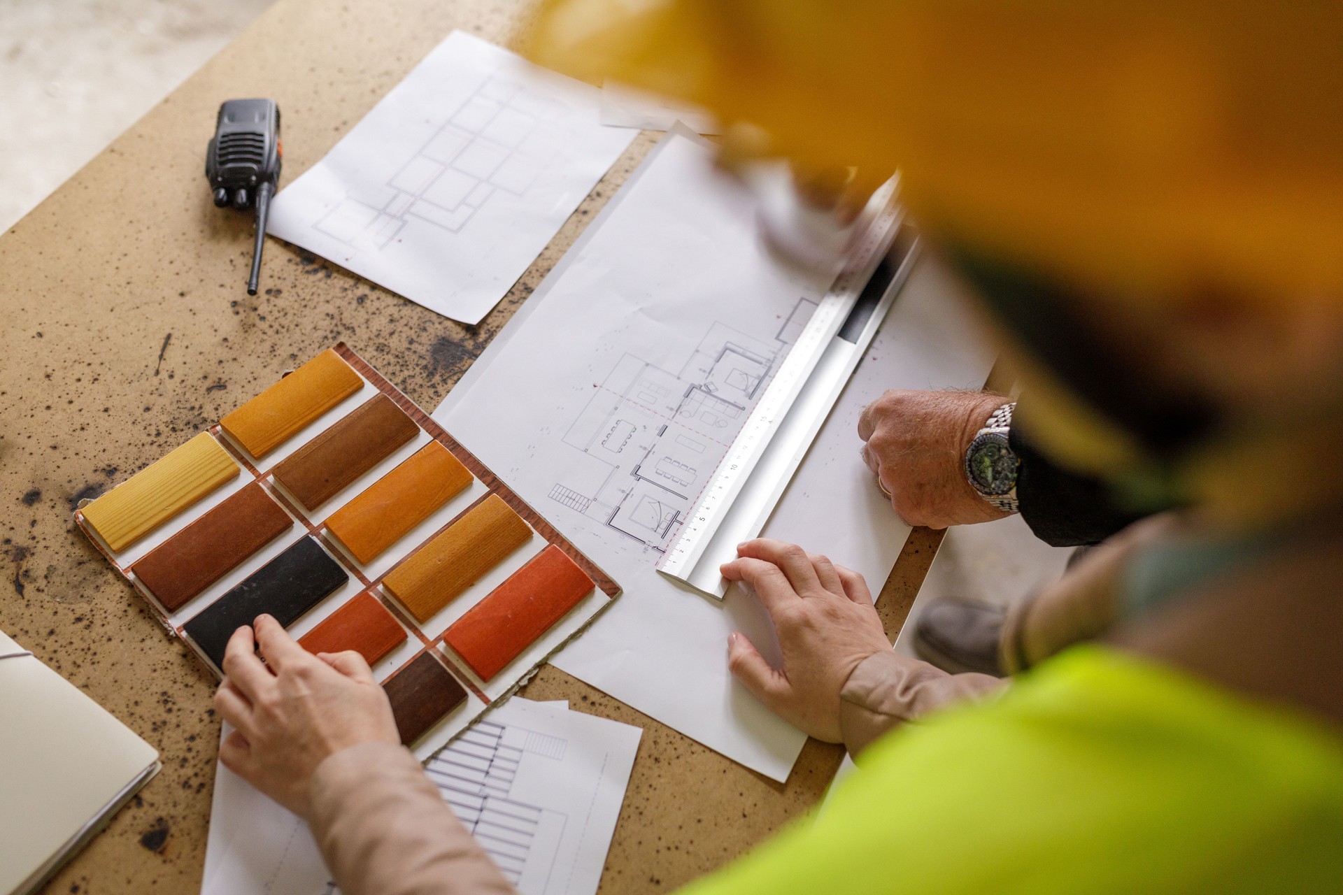 Architects examining blueprints rear