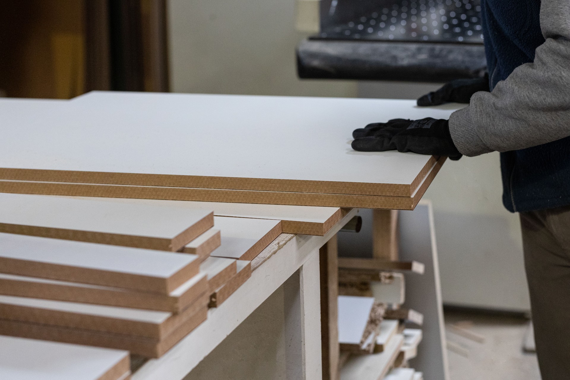 Workers measuring and cutting wood veneer plates n a wood factory