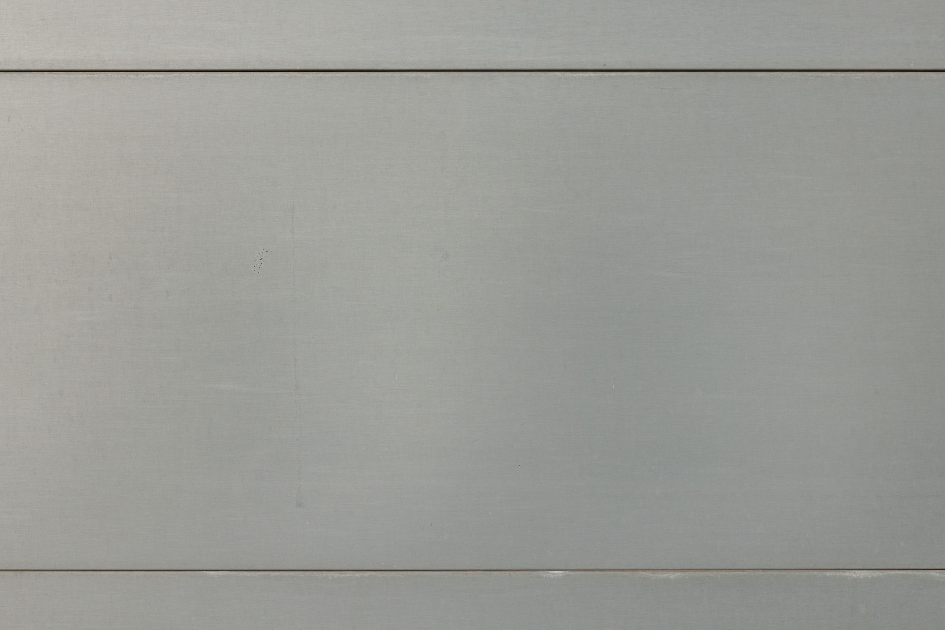 Part of a gray metal garage door