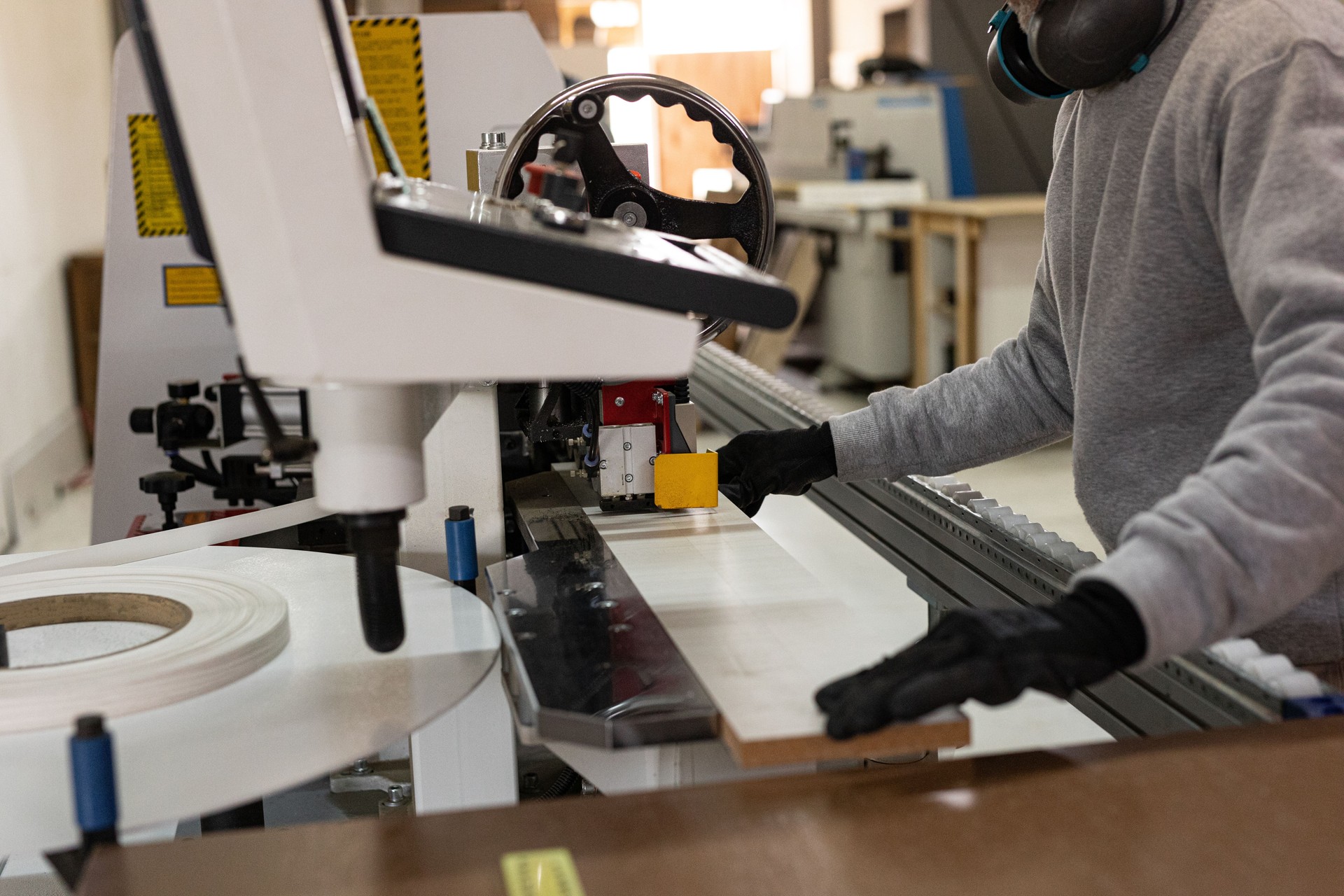 Workers measuring and cutting wood veneer plates n a wood factory
